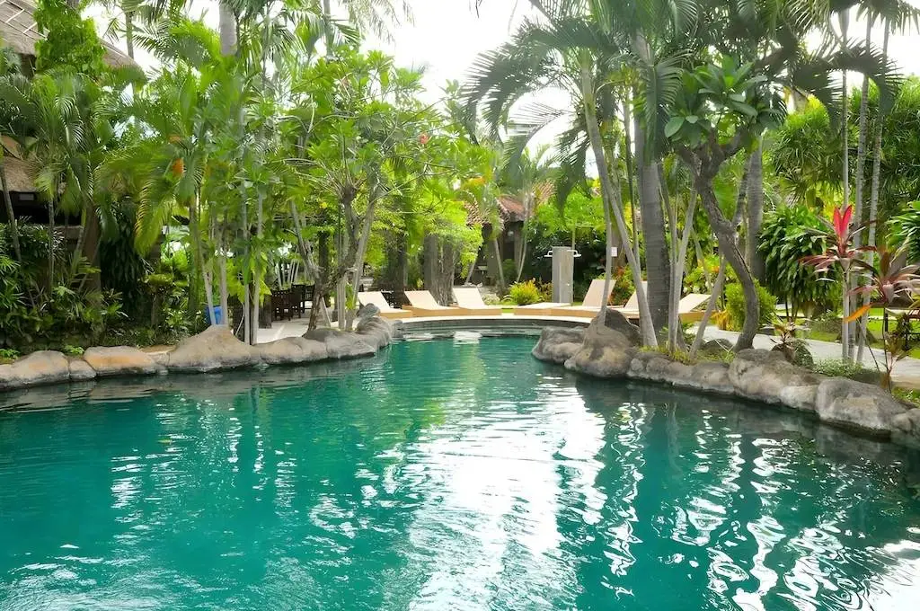 The lagoon-style pool at the place we stay in Amed, surrounded by palm trees