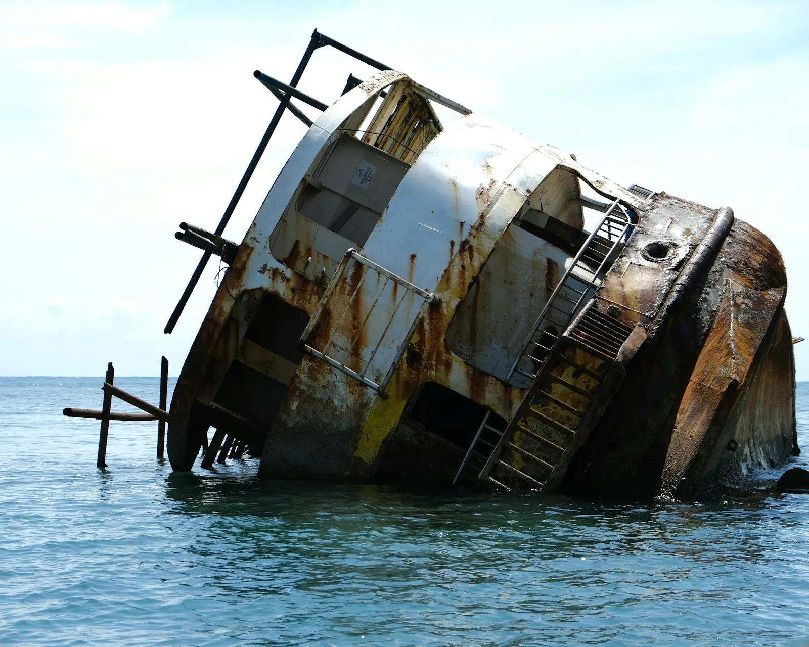 A rusted shipwreck at the surface. A wreck in Palawan, not named by the photographer