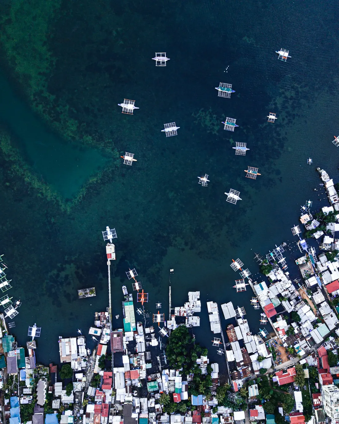 Outrigger boats in the harbour of Coron town, from above