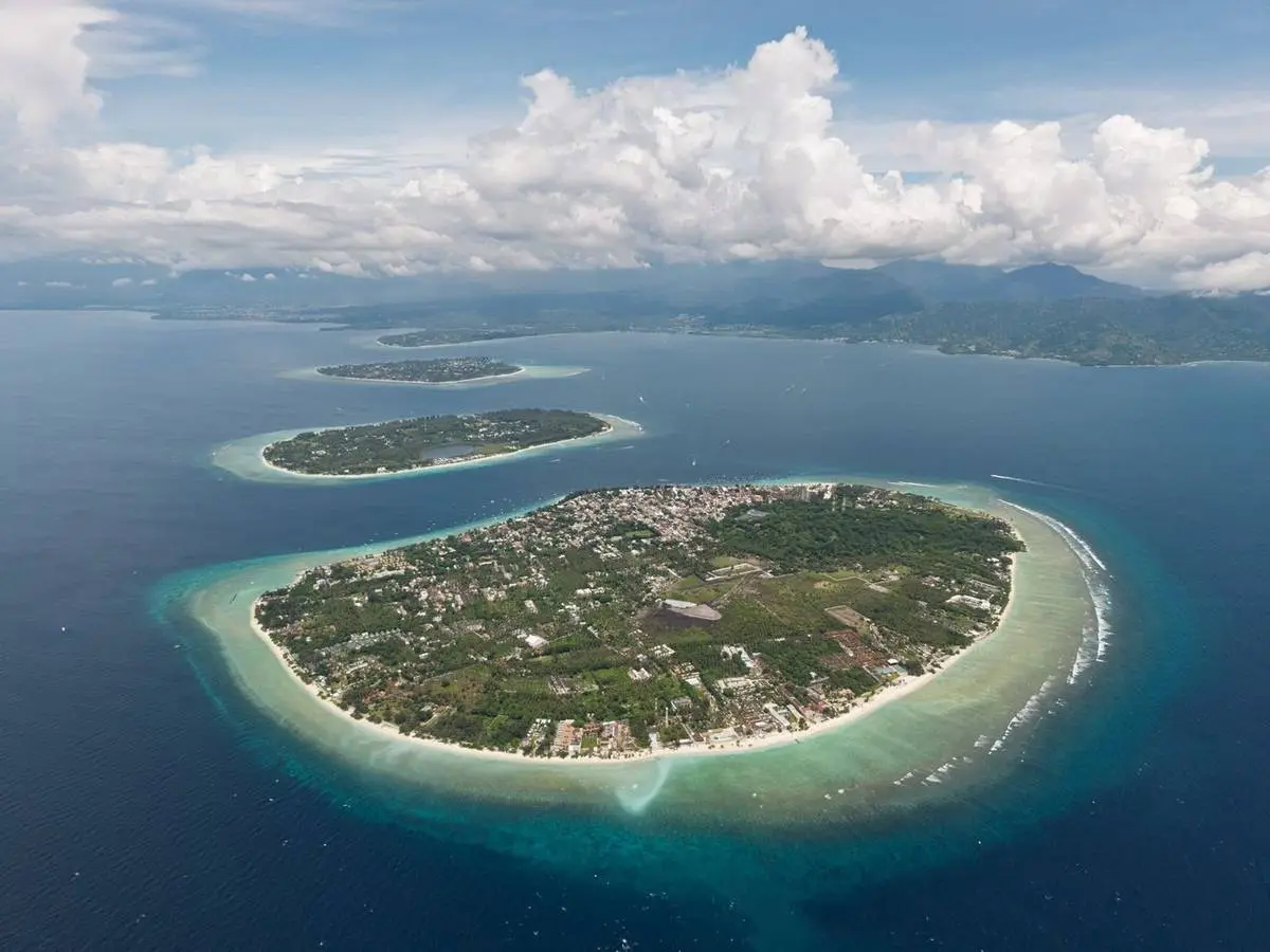 Gili Trawangan from the air, ringed by reef, with Gili Meno and Gili Air beyond