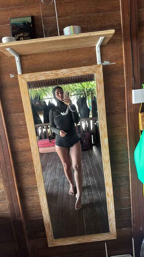 A guest smiling in a wetsuit before a freediving session