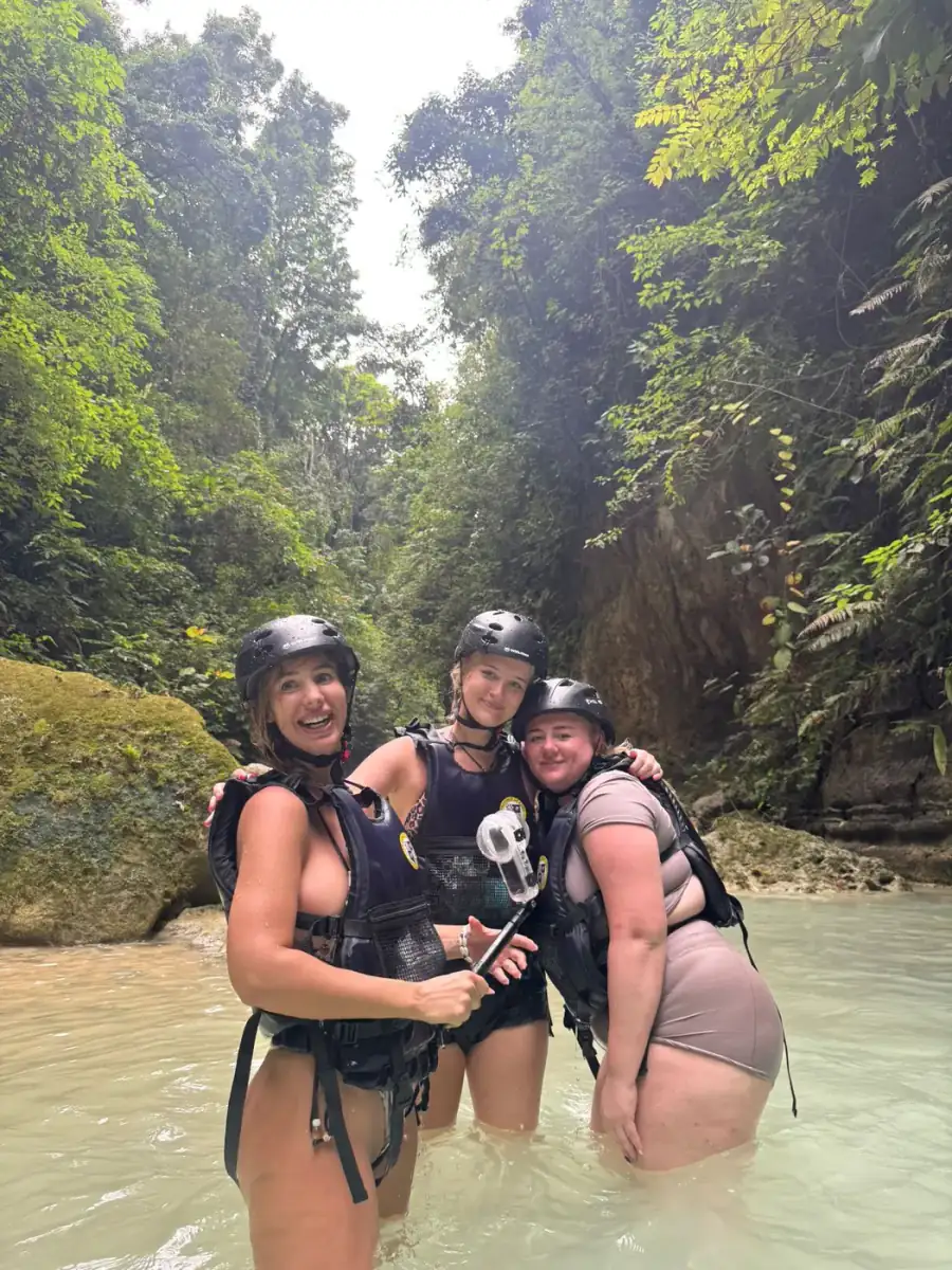 Three guests in helmets and life jackets on a canyon adventure