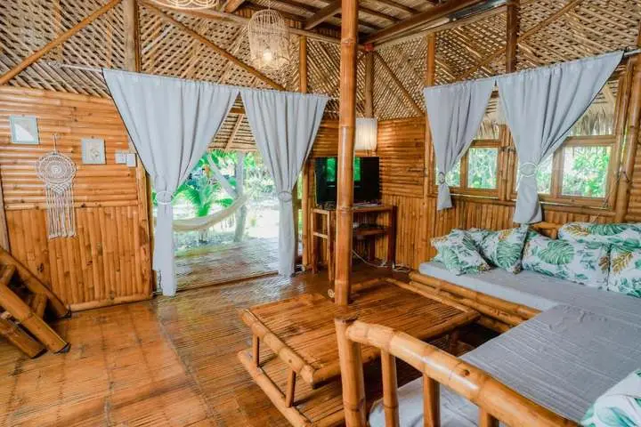 Bamboo cabin interior with white curtains