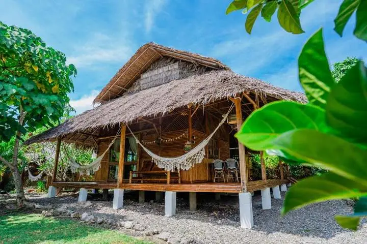 Thatched bamboo cabin with a hammock