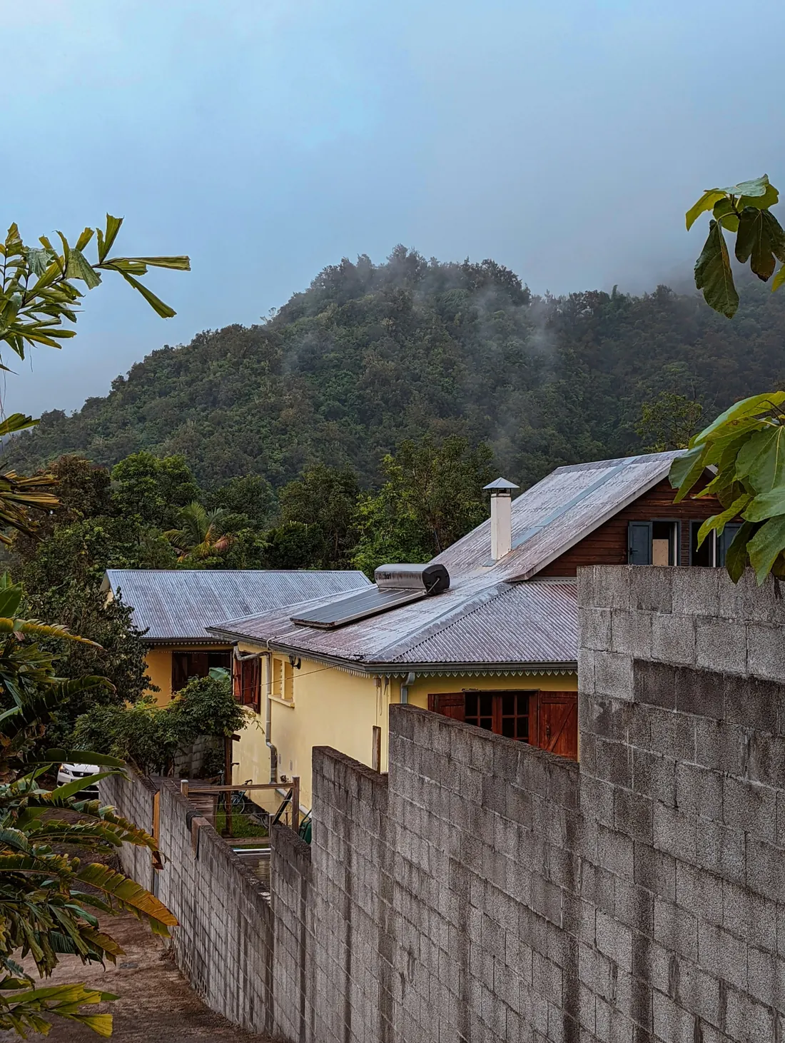 A village house in Hell-Bourg with the green walls of the Salazie cirque behind