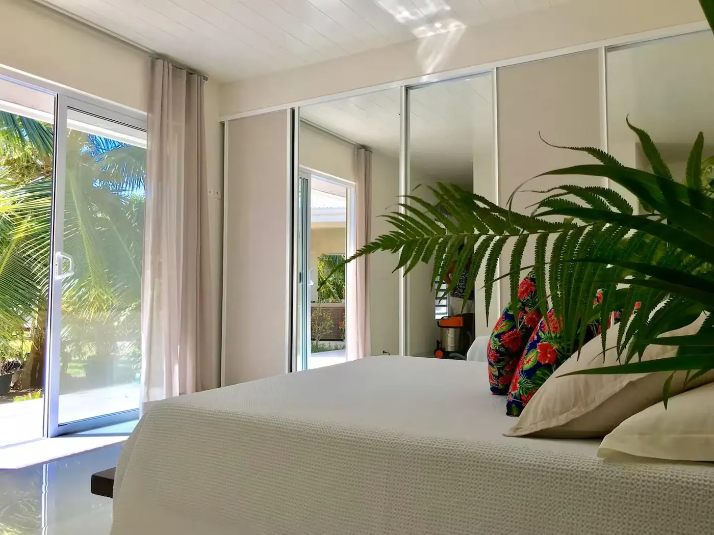 A villa bedroom with sliding doors to the garden