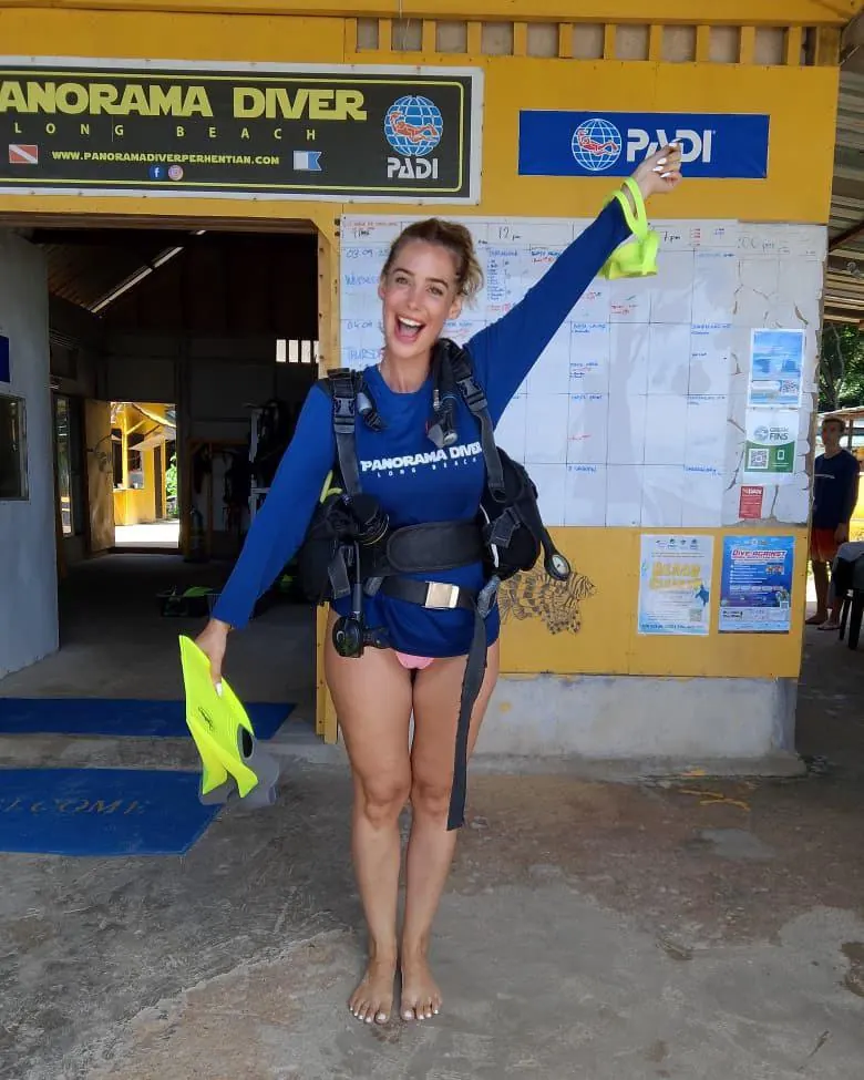Rocío smiling at a dive centre in Malaysia after a day of diving