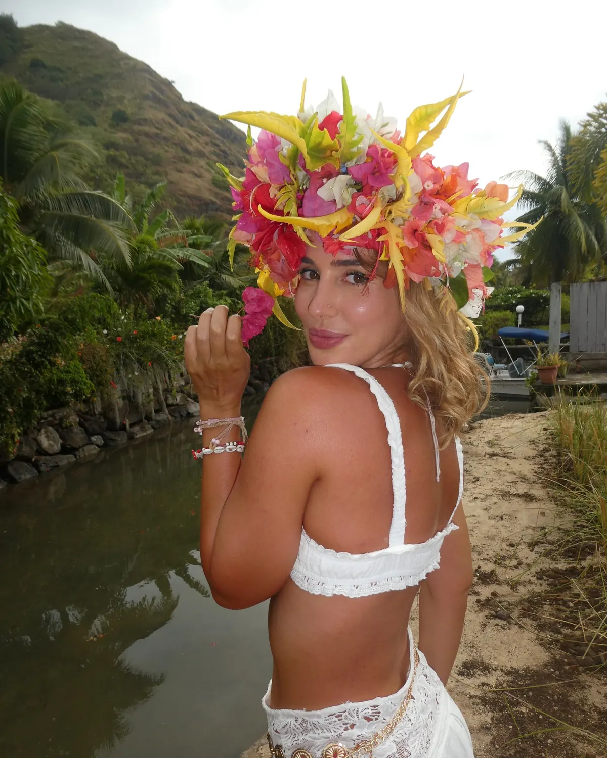 Rocío in a fresh flower crown by a river in Moʻorea